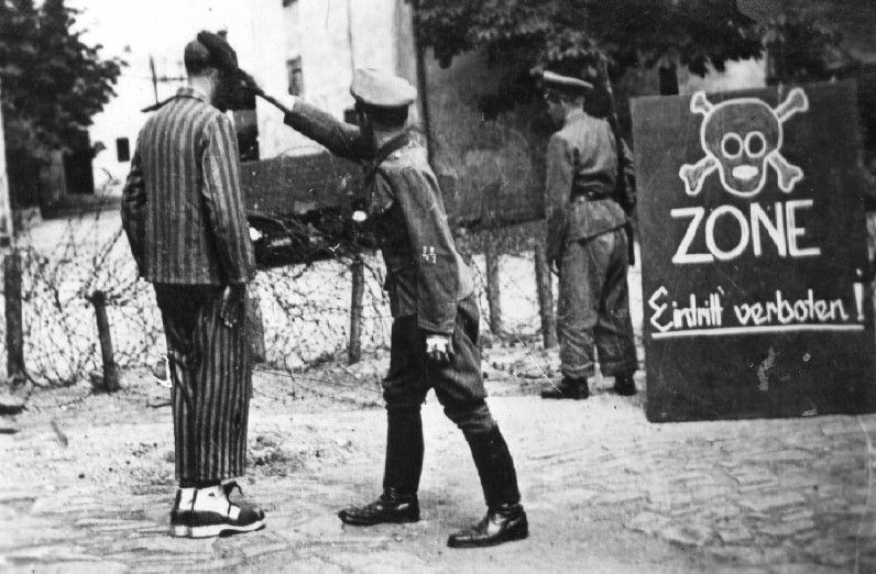 SS training photo showing an SS soldier abusing an inmate in a Nazi camp
